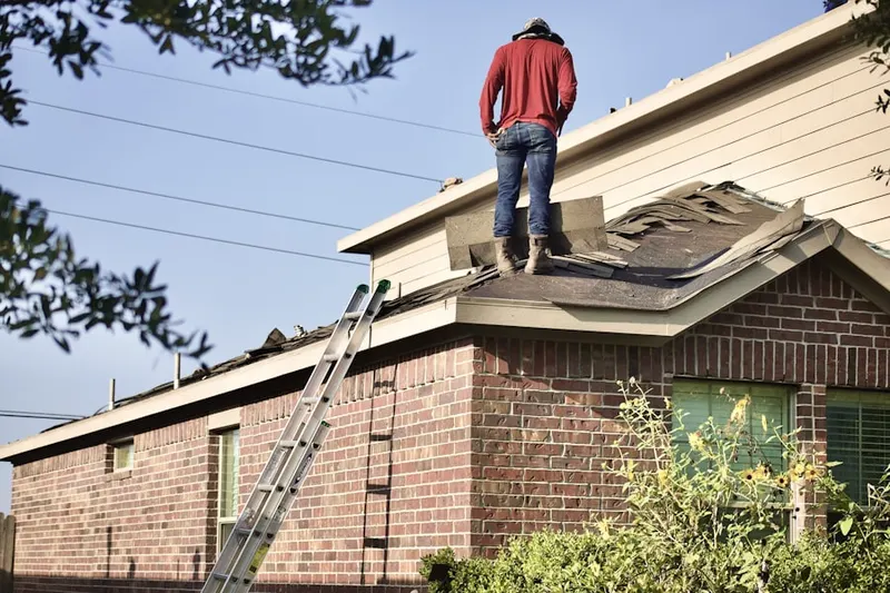 Professional roofer working on a residential roof in Crouch Mesa